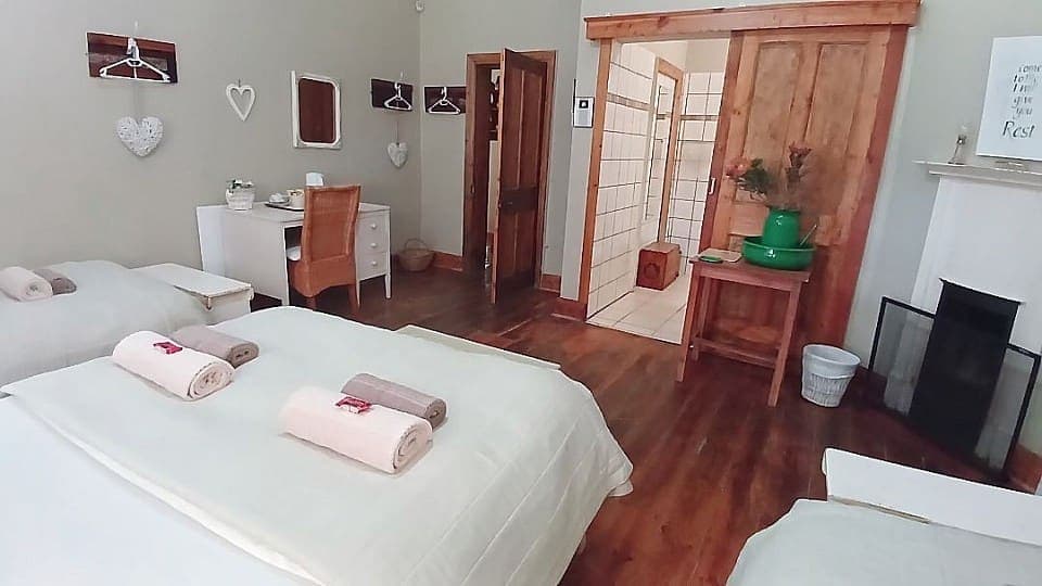 Calamus: looking across the beds to the fireplace and the open door of the en-suite shower room