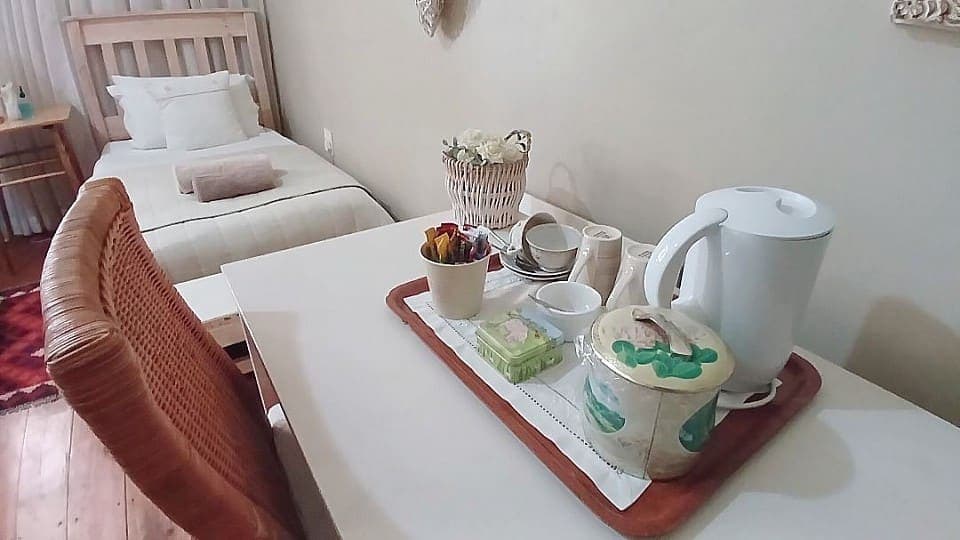 Calamus: the tea and coffee tray set out on the writing table, with the cane chair alongside