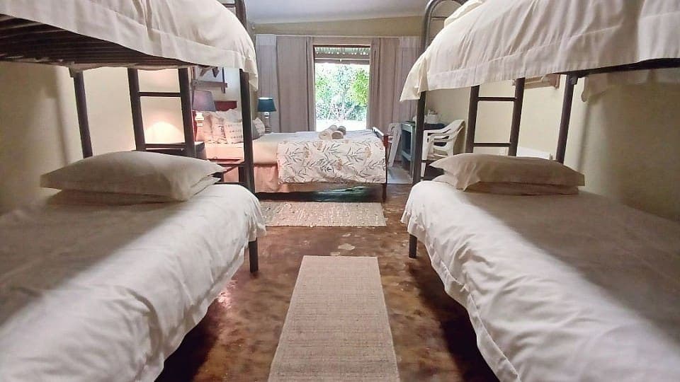 Frankincense: the two bunk beds, one on each side of the double bed, looking towards the garden doors
