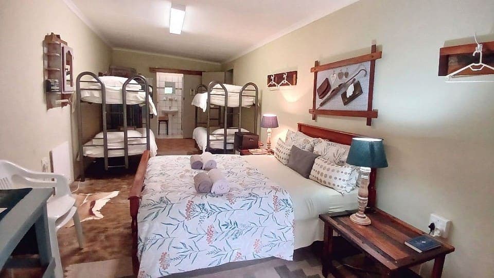Frankincense: the double bed and two bunk beds, with the en-suite shower room at the far end