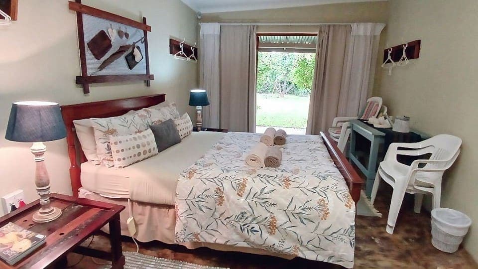 Frankincense: the double bed with the French doors open onto the lawn