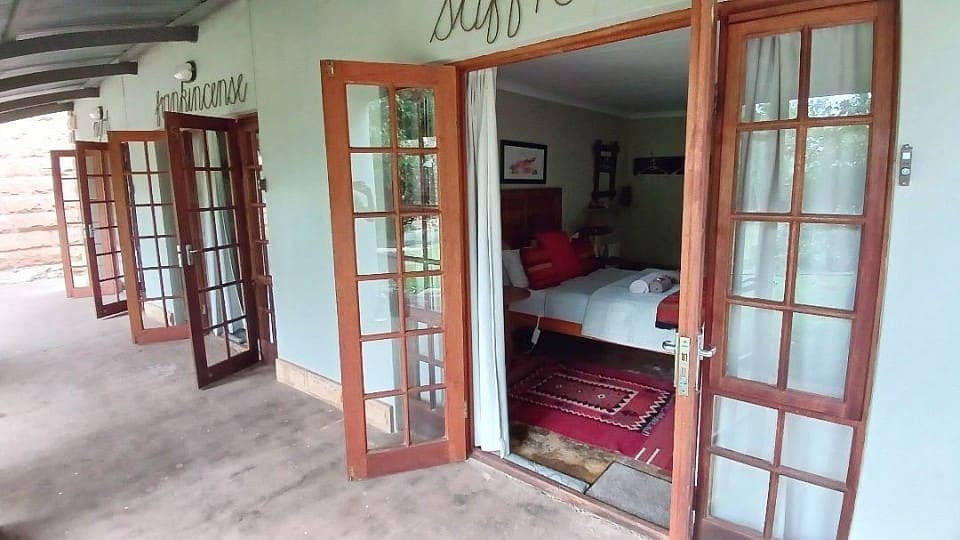 The covered walkway past the three garden rooms, each with its own pair of French doors