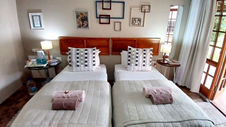 Myrrh: the beds and framed pictures beside the doors that open onto the garden