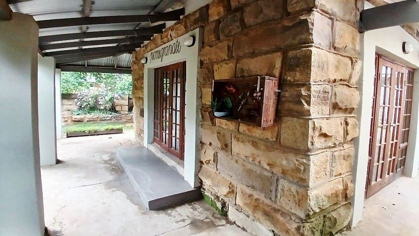 The entrance to the Pomegranate function hall, signed in script above a sandstone doorway