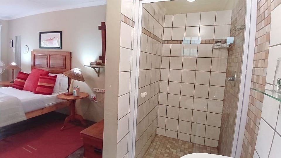 Saffron: the double bed with the door of the en-suite shower room standing open